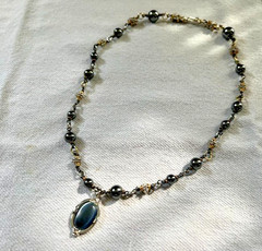 HEMATITE GRAY BEAD NECKLACE WITH SILVER/GOLD TONED SPACERS AND CABACHON PENDANT