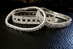 clear rhinestone stretch bracelets set in a silver-tone metallic base.