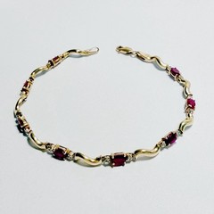 10K Gold Ruby & Diamond 7 “ bracelet. 8, 5mm faceted oval rubies & 16 diamonds.