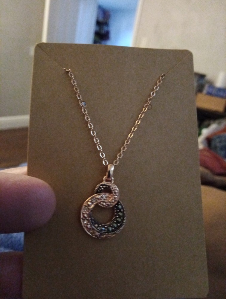 Rose Gold Colored Intwinned Circles With White And Black Stones costume jewelry