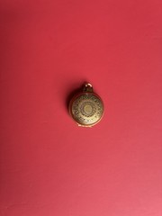 Round gold-tone brass locket