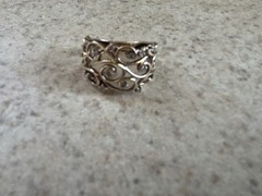 Gold ring with diamonds in swirly pattern