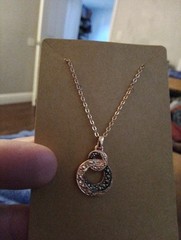Rose Gold Colored Intwinned Circles With White And Black Stones costume jewelry