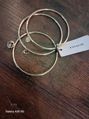 Coach NWT Gold Tone Stackable Bangle Bracelet Set, 3pc Logo With Dangle Charms