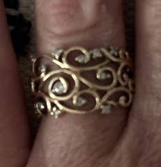 Gold ring with diamonds in swirly pattern